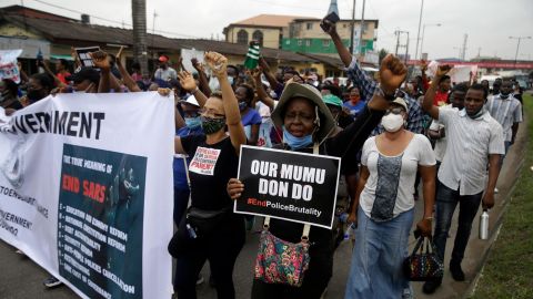 People hold banners as they demonstrate on the street to protest against police brutality in Lagos, Nigeria, Saturday Oct. 17, 2020.
