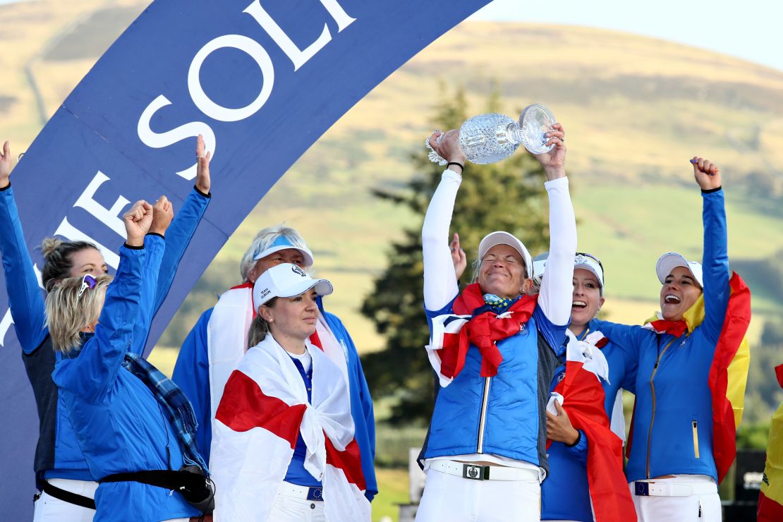 Suzann Pettersen of Team Europe lifts the trophy with her teammates after winning the Solheim Cup.