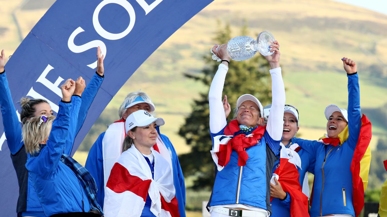 Suzann Pettersen of Team Europe lifts the trophy with her teammates after winning the Solheim Cup.