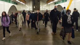 Passengers wearing face masks walk in the corridor of a metro station on October 13, 2020 in Prague.