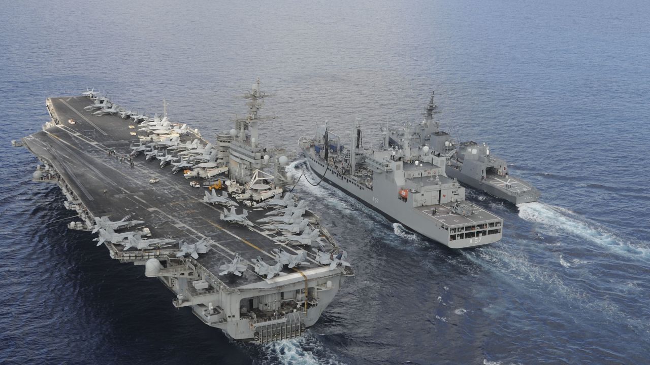 The aircraft carrier USS Theodore Roosevelt and Japanese Maritime Self-Defense Force Akizuki-class destroyer JS Fuyuzuki sail alongside the Indian Deepak-class fleet tanker INS Shakti during Exercise Malabar 2015.
