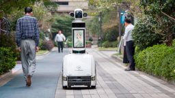 JINHUA, CHINA - OCTOBER 14: People watch a CloudMinds security guard robot which patrols at a residential community on October 14, 2020 in Jinhua, Zhejiang Province of China. (Photo by Hu Xiaofei/VCG via Getty Images)