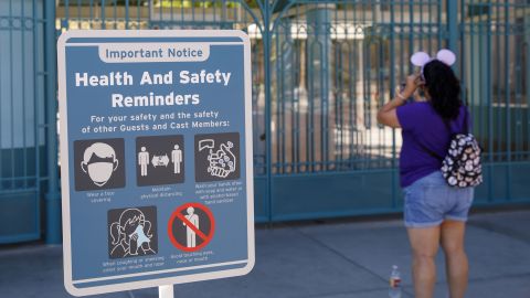 A "Health and Safety Reminders" sign is displayed outside the closed gates of California Adventure theme park, part of the Disneyland Resort, in Anaheim, California on Sept. 30, 2020.