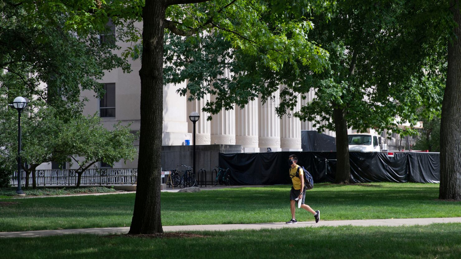 A student walks through the Diag on the University of Michigan campus in August. All Michigan undergraduates are now under a two-week emergency stay-at-home order. 