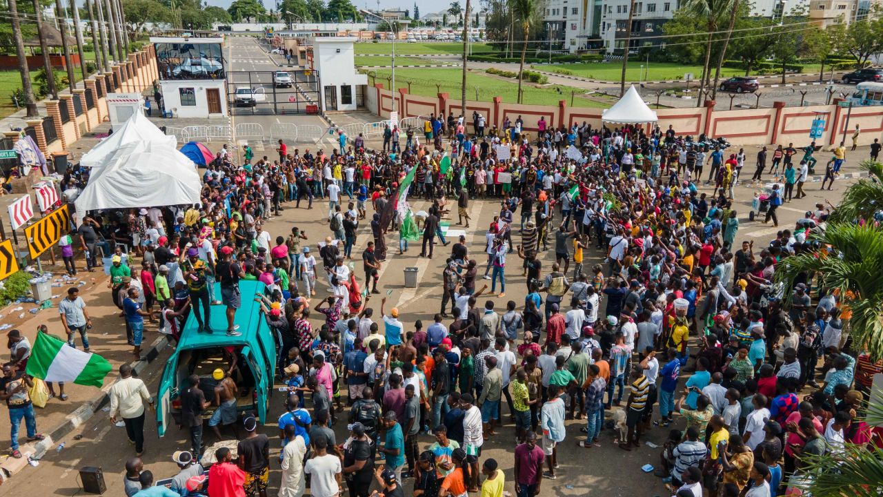 Protesters gather at the front of Alausa, the Lagos State Secretariat, while chanting a people united can never be defeated in Lagos on October 20, 2020, after the Governor of Lagos State, Sanwo Olu, declared 24-hour curfew in Nigeria's economic hub Lagos as violence flared in widespread protests that have rocked cities across the country. (Photo by Benson Ibeabuchi / AFP) (Photo by BENSON IBEABUCHI/AFP via Getty Images)