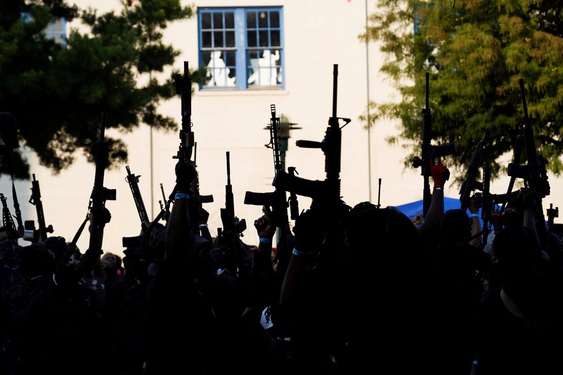 Members raised their weapons at Parc Sans Souci in Lafayette, Louisiana, on October 3.