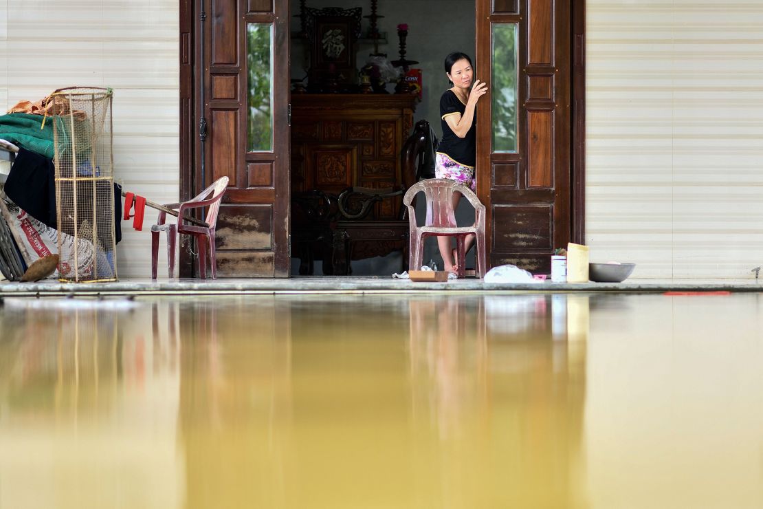 A woman looks out from her flooded house in Quang Dien district in central Vietnam's Hue province on October 15, 2020. 