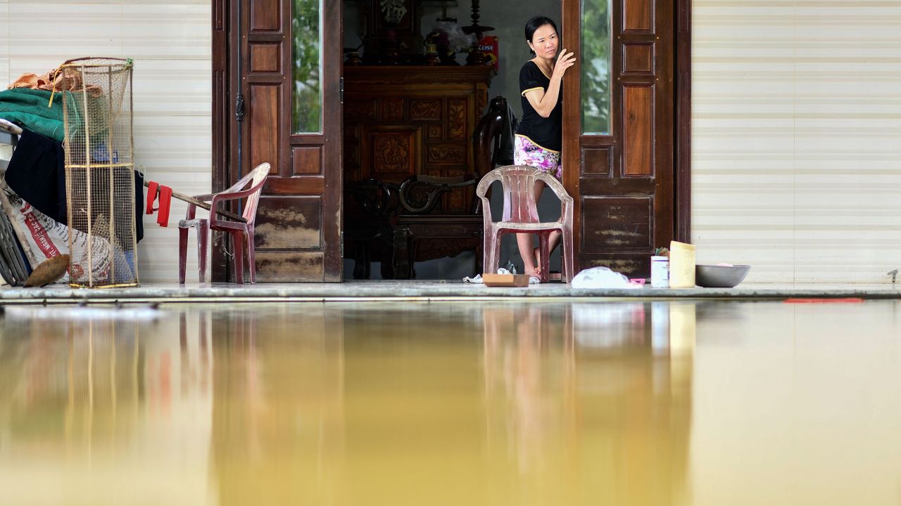 A woman looks out from her flooded house in Quang Dien district in central Vietnam's Hue province on October 15, 2020.