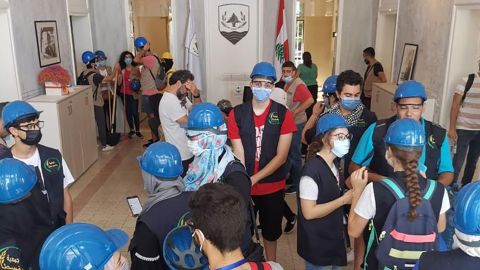 Activists gather at National Bloc headquarters, which was damaged during a deadly August 4 blast in Beirut, for a large clean-up campaign in the wake of the explosion.