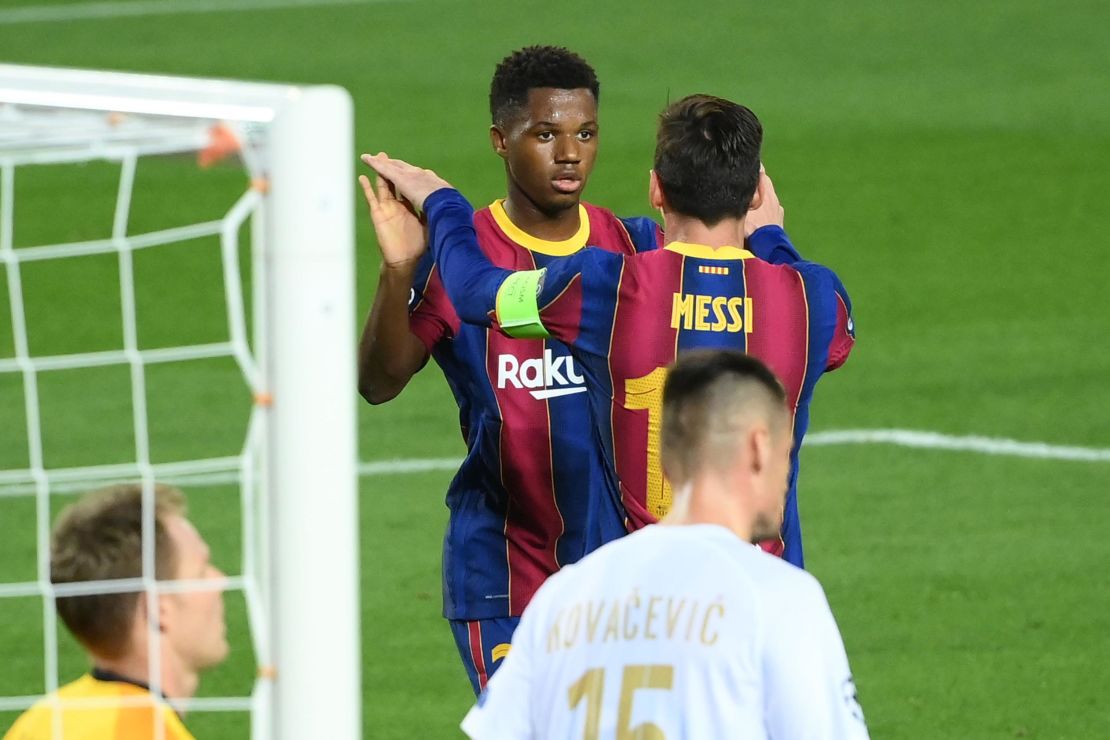 Ansu Fati celebrates with  Lionel Messi after scoring a goal during the UEFA Champions League football match between FC Barcelona and Ferencvarosi TC at the Camp Nou stadium on Tuesday.