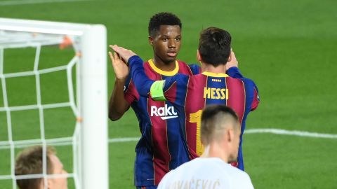Ansu Fati celebrates with Lionel Messi after scoring a goal against Ferencvarosi.