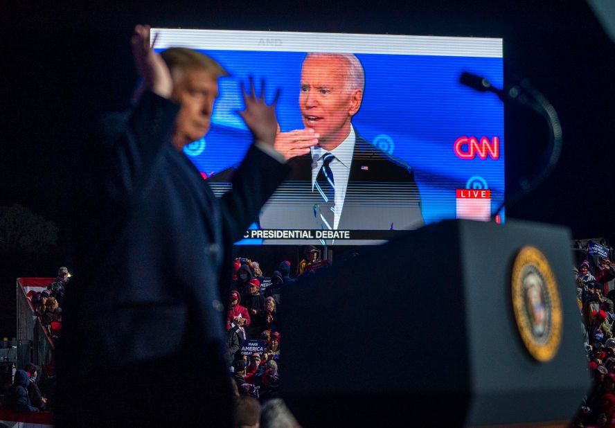 Trump throws up his hands as an ad from Biden's campaign was shown at his rally in Erie.