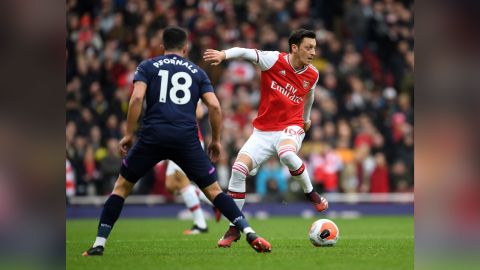 Ozil takes on Pablo Fornals of West Ham during a Premier League match on March 7, 2020.