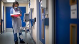 A doctor checks patient notes as the first patients are admitted to the NHS (National Health Service) Seacole Centre, a converted old military hospital at Headley Court, Surrey on May 28. 