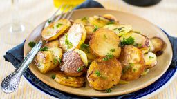 Fried potatoes with goose duck grease, garlic and parsley. Selective focus