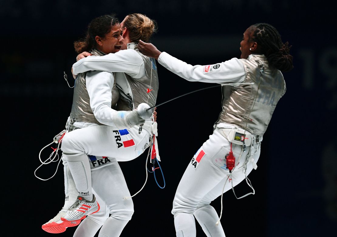 Thibus (L) of France celebrates with his team after winning against Jeon Her Sook of South Korea after the women's foil team competition final at the 2018 World Fencing Championships in Wuxi in China's eastern Jiangsu province in July 2018.