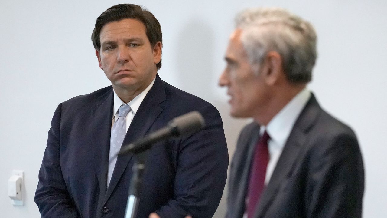 Florida Gov. Ron DeSantis, left, looks on as Dr. Scott Atlas, President Donald Trump's new pandemic advisor, gestures as during a news conference at the University of South Florida Morsani College of Medicine and Heart Institute Monday, Aug. 31, 2020, in Tampa, Fla. 
