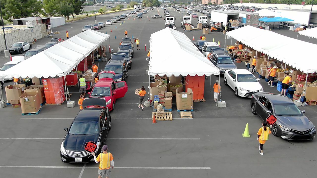People line up in their cars to receive food during a Second Harvest pop-up distribution site at California's Honda Center in June.