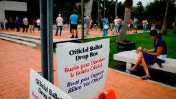 "Offcial ballot drop box" signs are seen at Westchester Regional Library in Miami, Florida on October 19, 2020. - Early voting kicked off Monday in Florida, a pivotal state fought over relentlessly by President Donald Trump and Democratic challenger Joe Biden as their contentious White House race enters its final 15-day stretch. Record numbers of Americans have already cast ballots in person or by mail -- 28.6 million, according to one tracker -- ahead of the November 3 election, as the rivals race from one swing state to another to marshal support. (Photo by Eva Marie UZCATEGUI / AFP) (Photo by EVA MARIE UZCATEGUI/AFP via Getty Images)