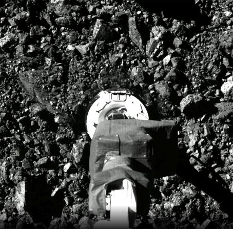 This image shows the moment the spacecraft briefly used its robotic arm to touch the surface of Bennu, crushing porous rocks in the process.