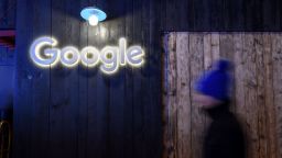 A man passes by a sign of Google at Google's stand during the annual meeting of the World Economic Forum (WEF) in Davos, on January 21, 2020. (Photo by Fabrice COFFRINI / AFP) (Photo by FABRICE COFFRINI/AFP via Getty Images)