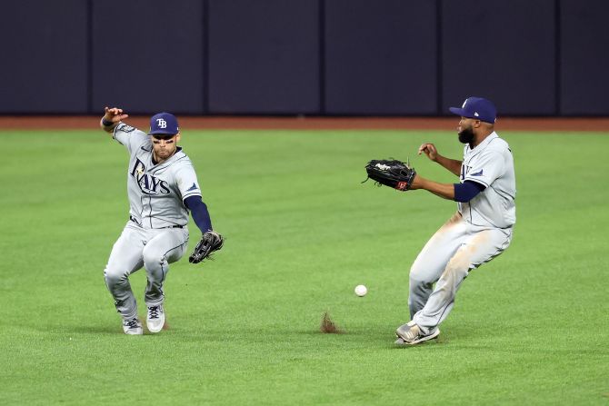 Rays outfielders Kevin Kiermaier, left, and Manuel Margot fail to catch a fly ball hit by Dodgers third baseman Justin Turner.