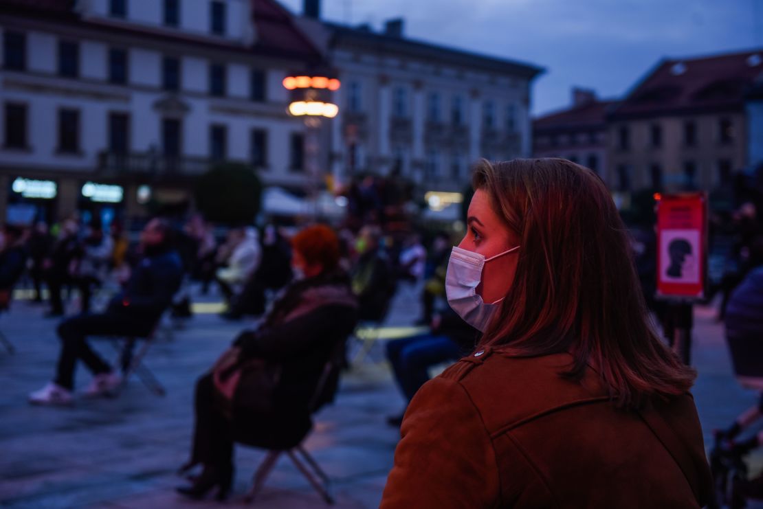A woman wears a mask during a socially-distanced concert to celebrate the 100th anniversary of the birth of former Pope John Paul II, in Wadowice, Poland on October 18.