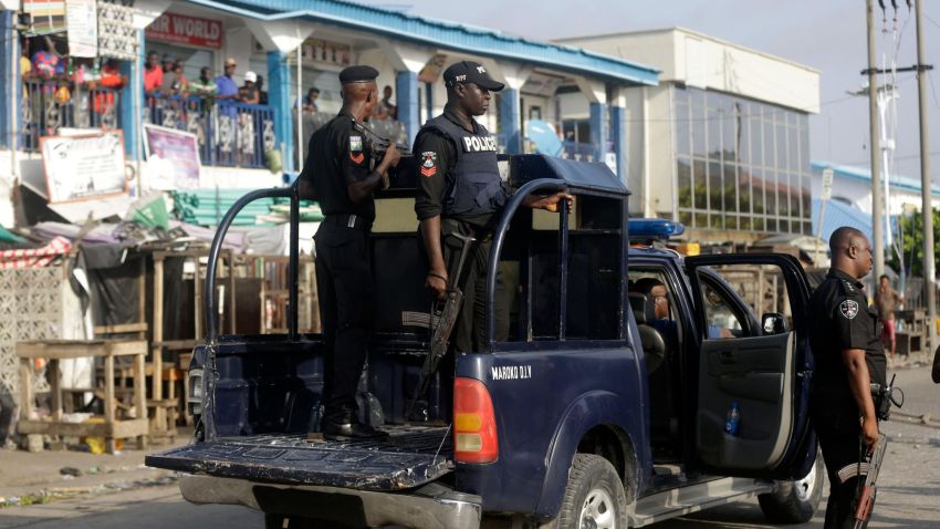 Police officers patrol near the Lekki toll gate in Lagos, Nigeria, Wednesday Oct. 21, 2020.  After 13 days of protests against alleged police brutality, authorities have imposed a 24-hour curfew in Lagos, Nigeria's largest city, as moves are made to stop growing violence.  ( AP Photo/Sunday Alamba)