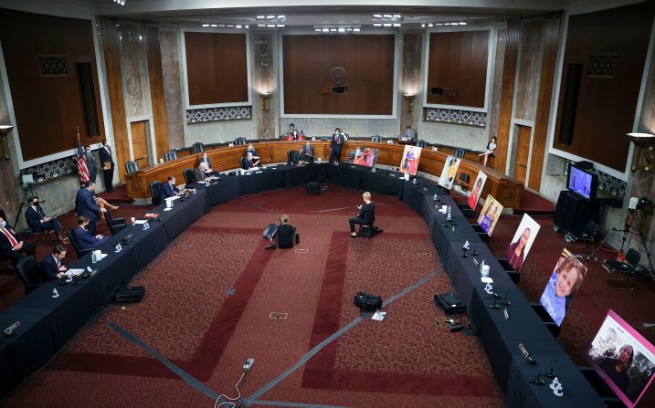 Portraits of people who rely on the Affordable Care Act are seen in the seats of Democratic senators who boycotted <a  target="_blank">the vote of the Senate Judiciary Committee</a> on October 22. The vote to advance Barrett to the full Senate passed 12-0.