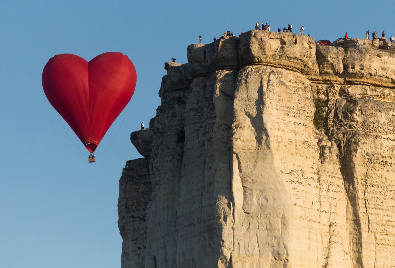 <strong>Crimea:</strong> A heart-shaped balloon flies near the Aq Qaya (White Rock) plateau as part of the Crimean Sky Balloon Festival held in September. 