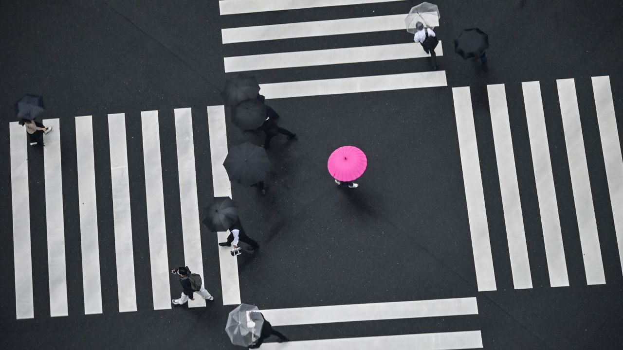 <strong>Tokyo: </strong>Umbrella-holding pedestrians cross the street in the Japanese capital. 