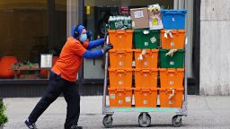 A FreshDirect delivery person pushes a cart with groceries during the coronavirus pandemic on April 27, 2020 in New York City. COVID-19 has spread to most countries around the world, claiming over 211,000 lives and infecting over 3 million people. (Photo by Cindy Ord/Getty Images)