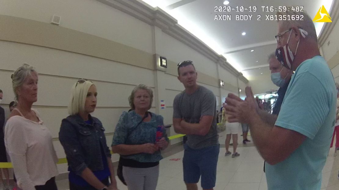 Police officers and a poll worker talk with four voters who refused to wear masks during early voting in Fort Lauderdale, Florida, on Monday. The voters, who said they had severe asthma, were eventually allowed to cast their ballots. (Courtesy Fort Lauderdale Police Department)