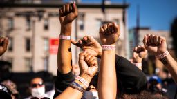 LOUISVILLE, KY - OCTOBER 13: Black Lives Matter protesters display their I VOTED wristbands after leaving the polling place at the KFC YUM! Center on October 13, 2020 in Louisville, Kentucky.  Tuesday marked the first day of early in-person voting in Kentucky, which lasts through November 2. (Photo by Jon Cherry/Getty Images)