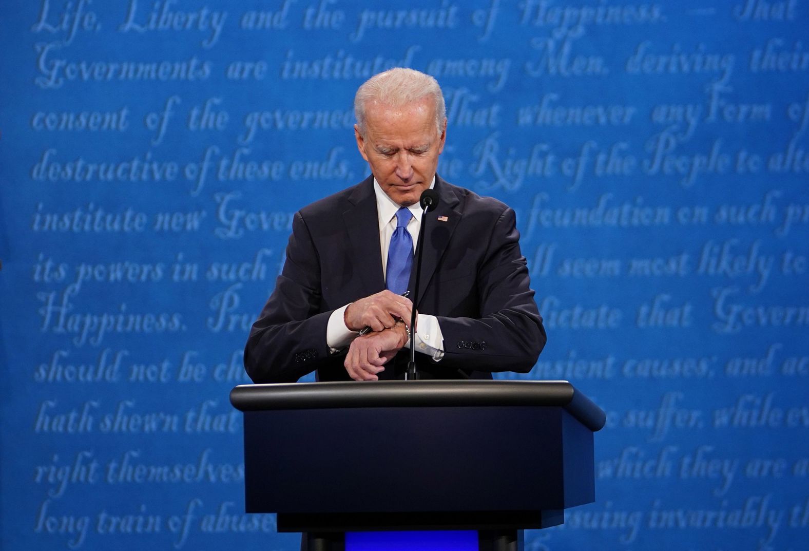 Biden looks at his watch during the debate. It lasted a little over 90 minutes.