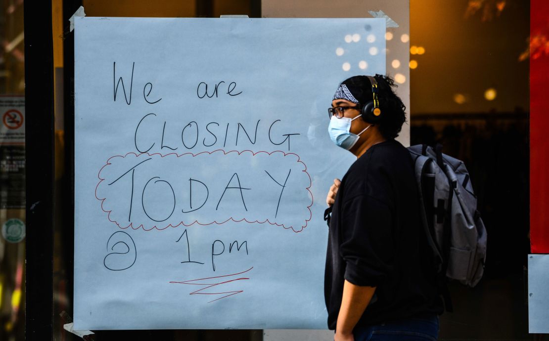 A handwritten sign on a window of a shop announces its closure in Swansea city centre, south Wales, a day before the "fire-break" lockdown comes into force.