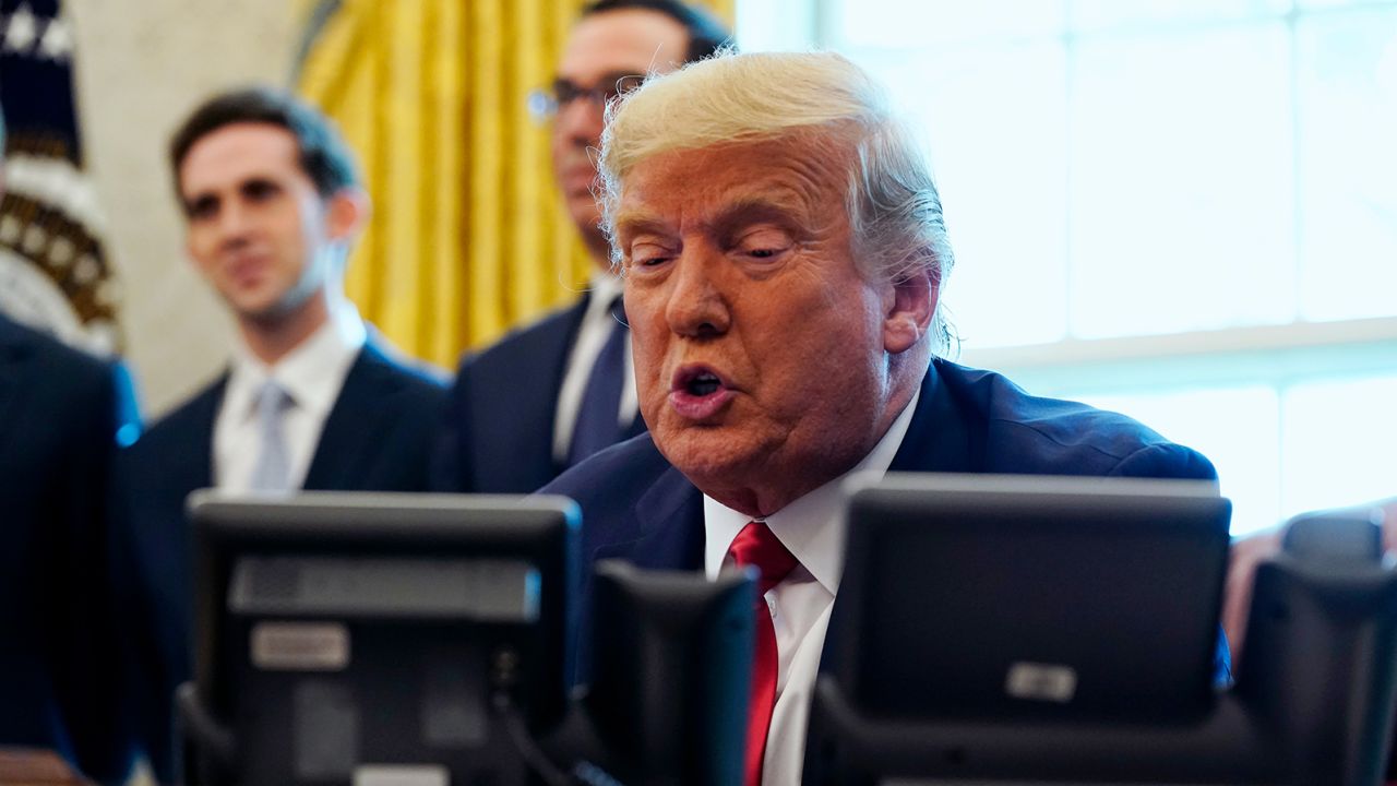 President Donald Trump speaks while on a phone call with leaders of Sudan and Israel in the Oval Office of the White House, Friday, Oct. 23, 2020, in Washington. (AP Photo/Alex Brandon)