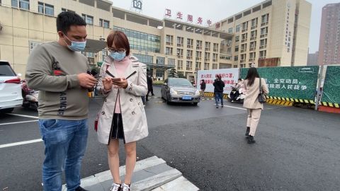 Guangdong resident Anny Ku stands in front of a hospital in the eastern Chinese city of Yiwu, where she is trying to get an experimental coronavirus vaccine.