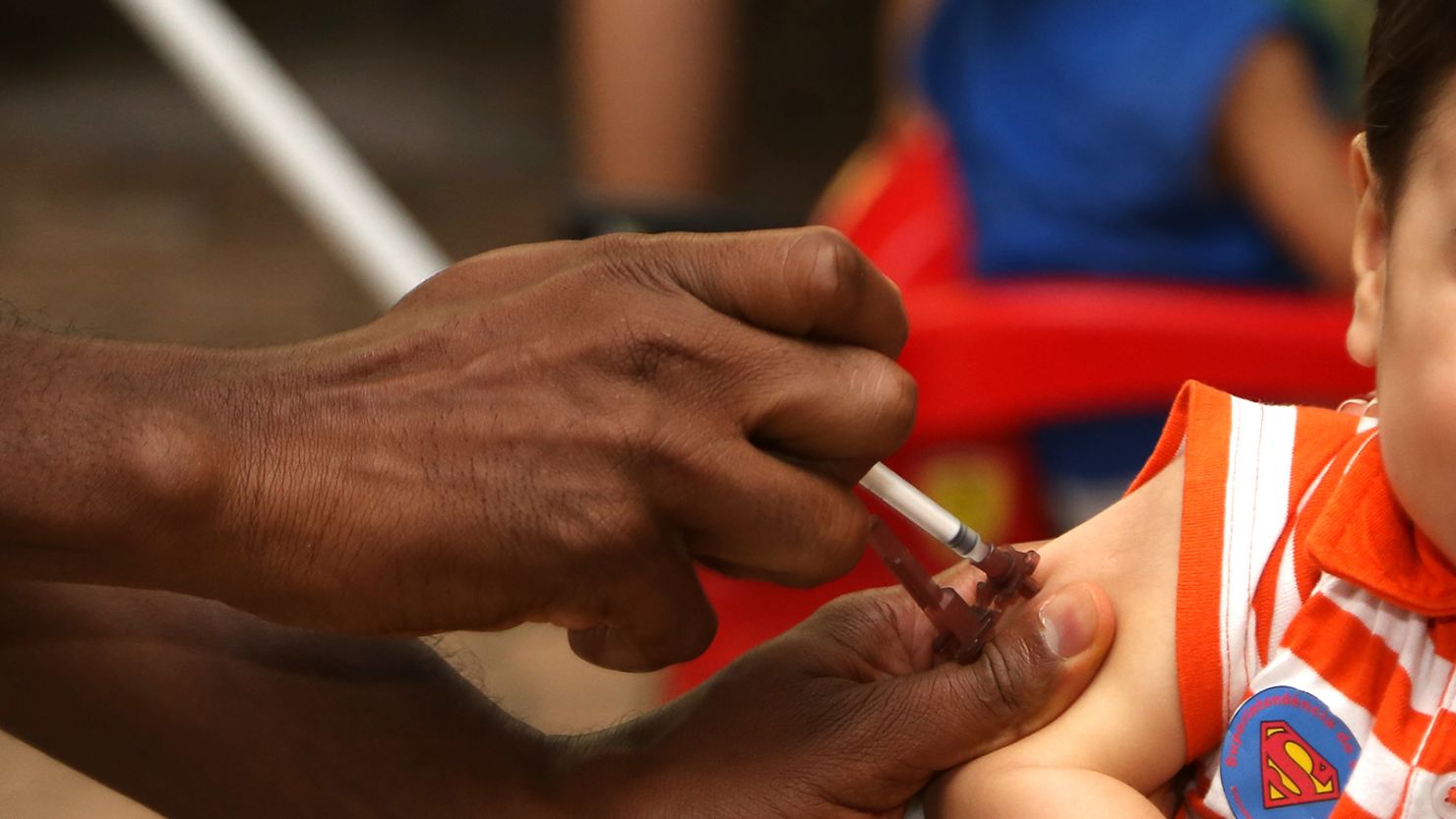 A health care worker administers a polio vaccine to a child in Brasilia, Brazil, on October 17.