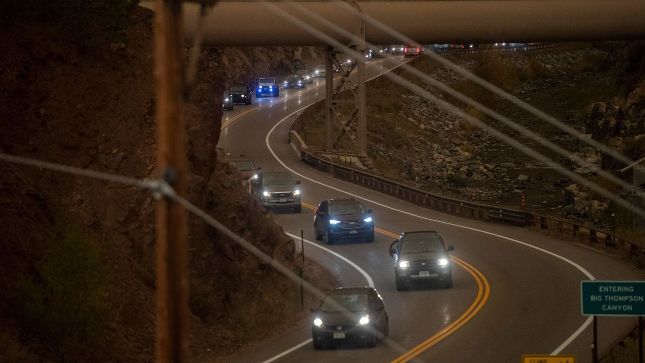 Evacuees drive along US Highway 34 on Thursday, October 22.