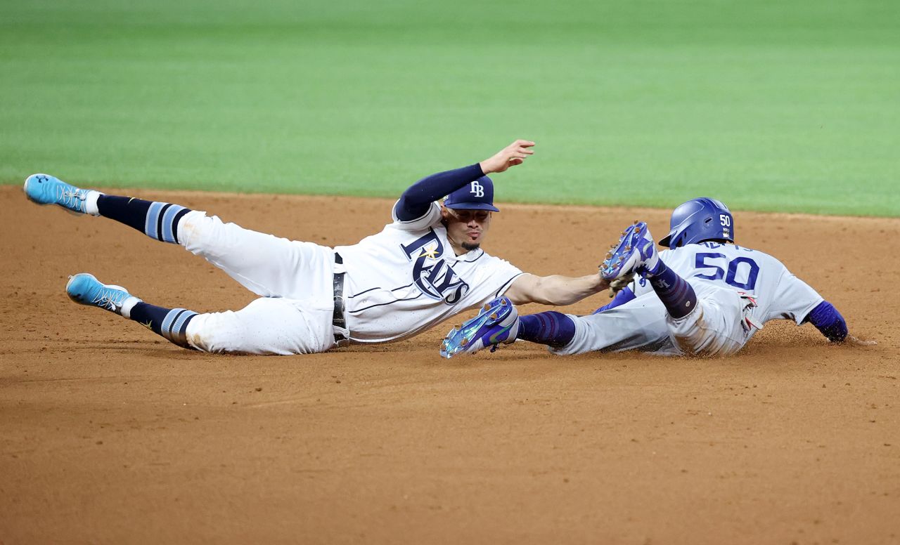 The Dodgers' Mookie Betts  steals second base against Willy Adames during the sixth inning of Game 3.