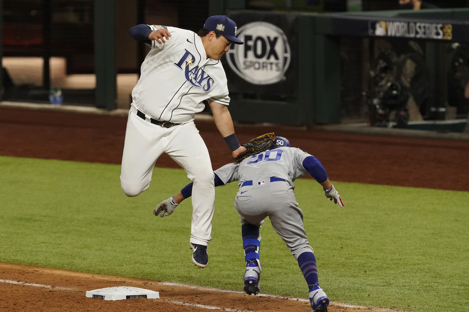 The Dodgers beat the Rays 6-2 in Game 3 on Friday, October 23, taking a 2-1 series lead. Here, Rays' first baseman Ji-Man Choi tags out Mookie Betts at first base during the eighth inning.