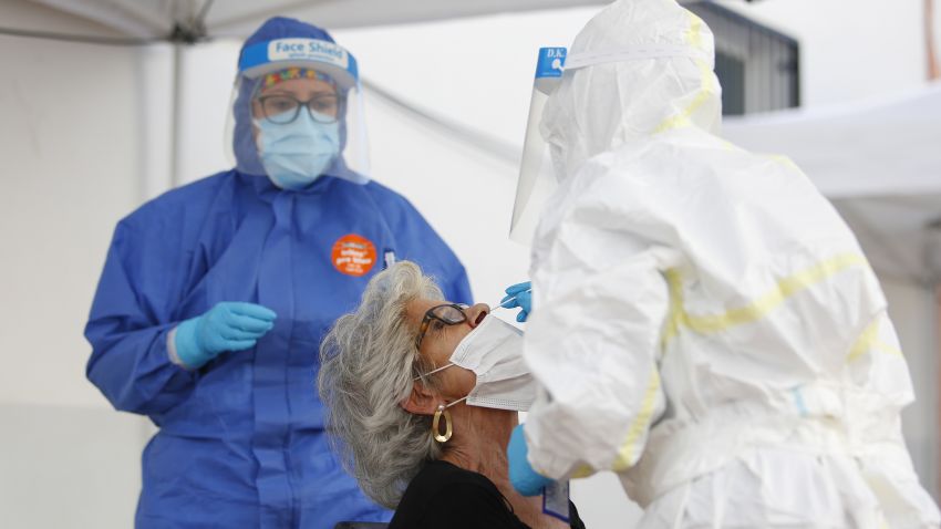 Health workers in Personal Protective Equipment (PPE) suits collect a swab sample from people during the express COVID-19 testing in Alfacar, Granada, Spain  on October 08, 2020. (Photo by Álex Cámara/NurPhoto via Getty Images)