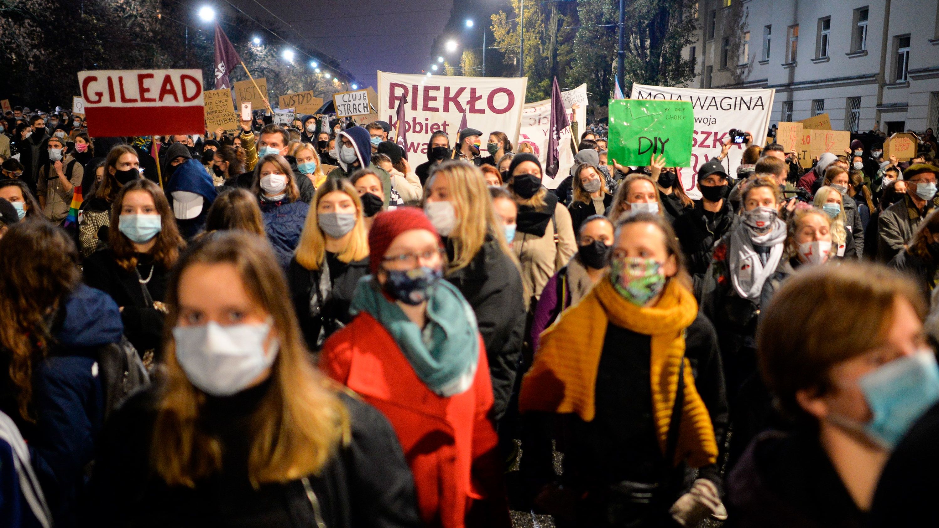  Activists hold placards as they protest in Warsaw against the abortion ban.