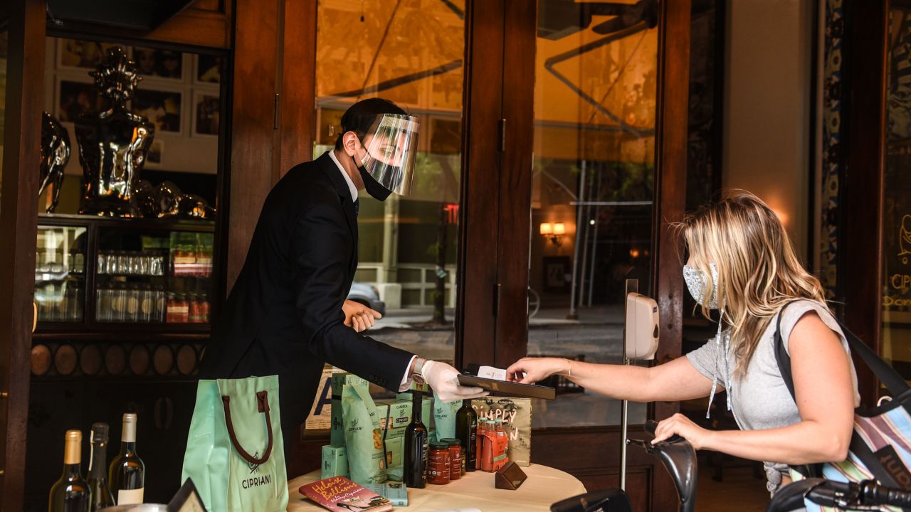 A customer pays for a to-go order at Cipriani restaurant on May 22, 2020, in New York's Soho neighborhood.
