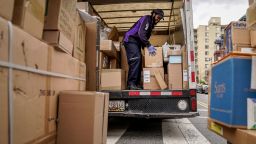 A FedEx worker unloads packages from his delivery truck on March 31, 2020 in Washington, DC. 