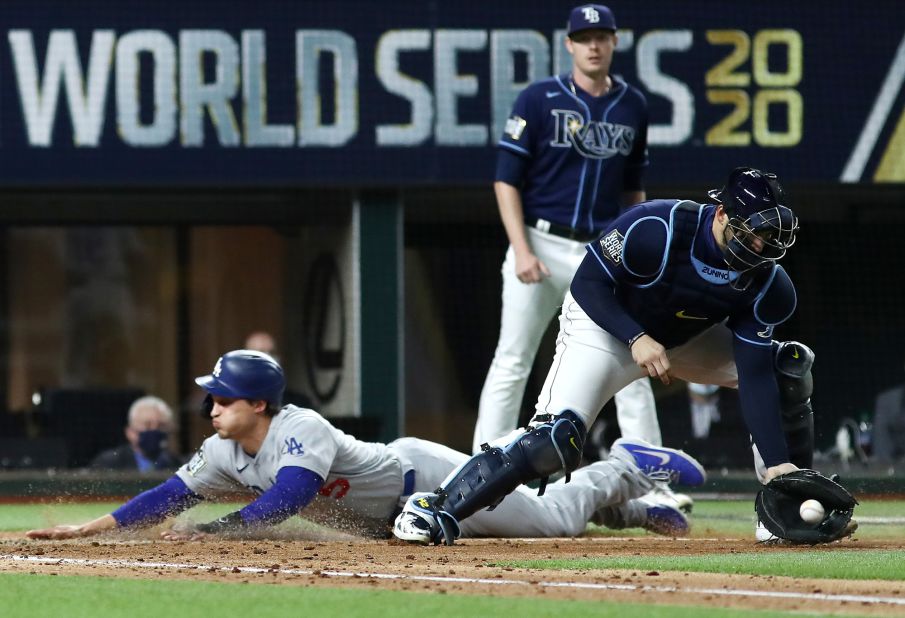 The Dodgers' Corey Seager slides into home plate safely with a run against the Rays during the fifth inning. 
