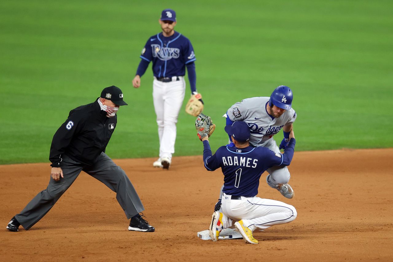 The Dodgers' Max Muncy is tagged out at second base by the Rays' Willy Adames during the fifth inning. 