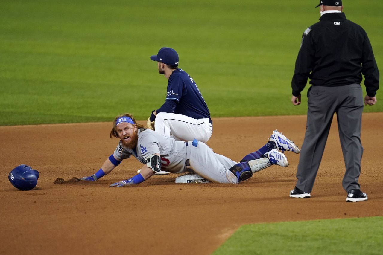 The Dodgers' Justin Turner slides into second base with a double in the seventh inning during Game 4. 