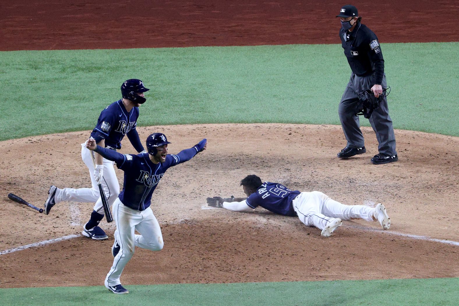 The Rays' Randy Arozarena slides into home plate during the ninth inning to score the winning run in Game 4. 